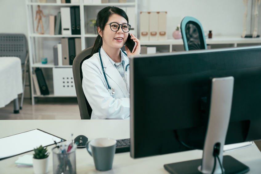 medical worker listening to patient on smartphone