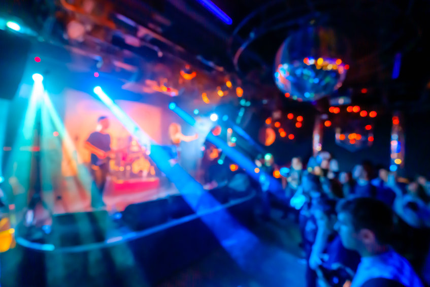Music band performing live at night club, blurred